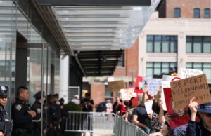 Protesters rally against Elon Musk at Tesla showrooms over the continued U.S. government purge