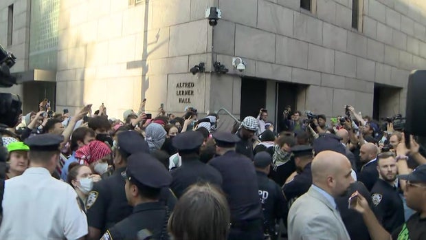 NYPD officers clash with a large crowd of protesters.