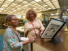 Black Californians Invited to Share Their Stories Through New Community Oral History Initiative Exhibit curator Kellie Todd Griffin shares the Museum of Black Women and Girls Pop-Up with an oral history project participant at the A C Bilbrew Library.