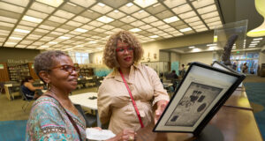 Black Californians Invited to Share Their Stories Through New Community Oral History Initiative Exhibit curator Kellie Todd Griffin shares the Museum of Black Women and Girls Pop-Up with an oral history project participant at the A C Bilbrew Library.