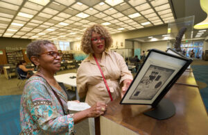 Black Californians Invited to Share Their Stories Through New Community Oral History Initiative Exhibit curator Kellie Todd Griffin shares the Museum of Black Women and Girls Pop-Up with an oral history project participant at the A C Bilbrew Library.